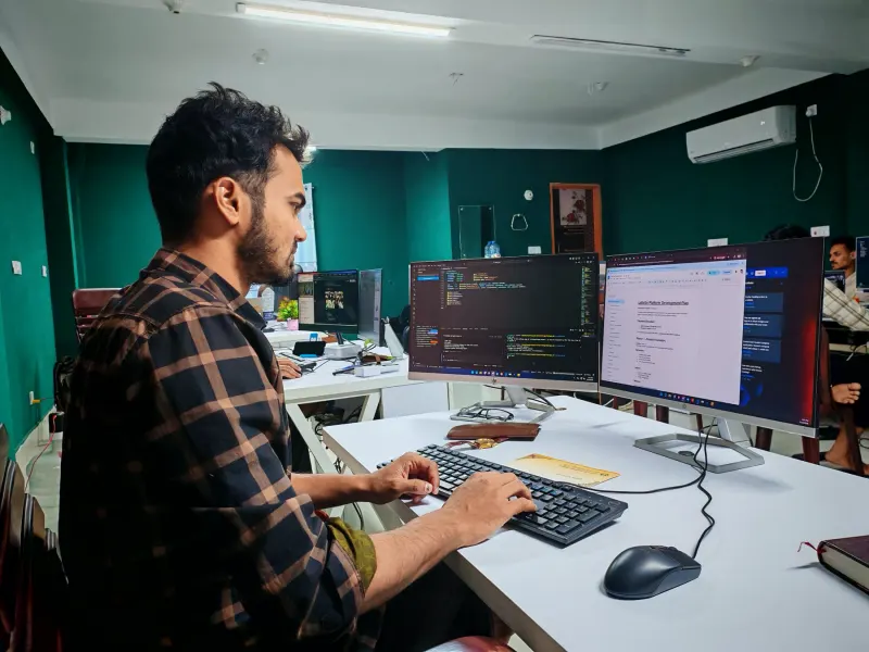 A developer building an automation at a dual monitor setup